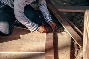 Read more about the article Worker Measuring Size Wood For Renovation